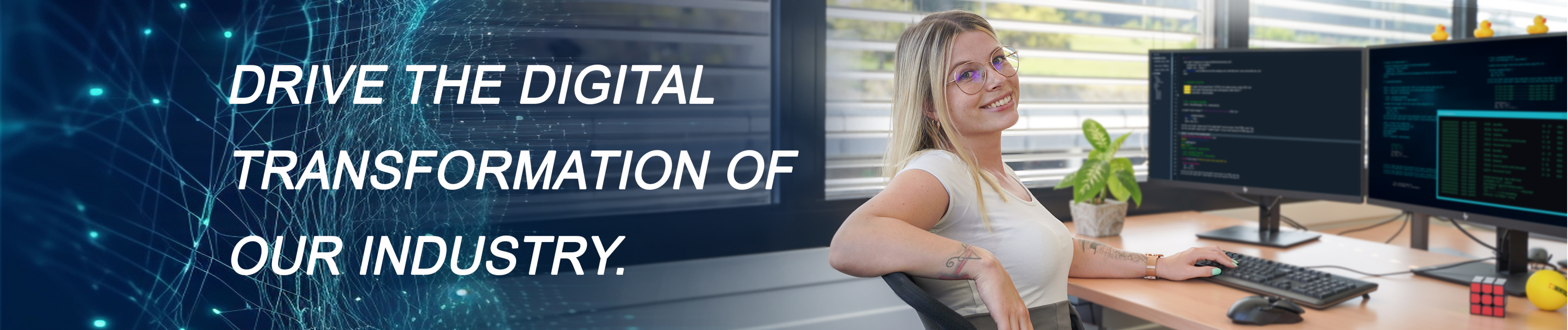 IT employee on her desk with the text "drive the digital transformation of our industry"