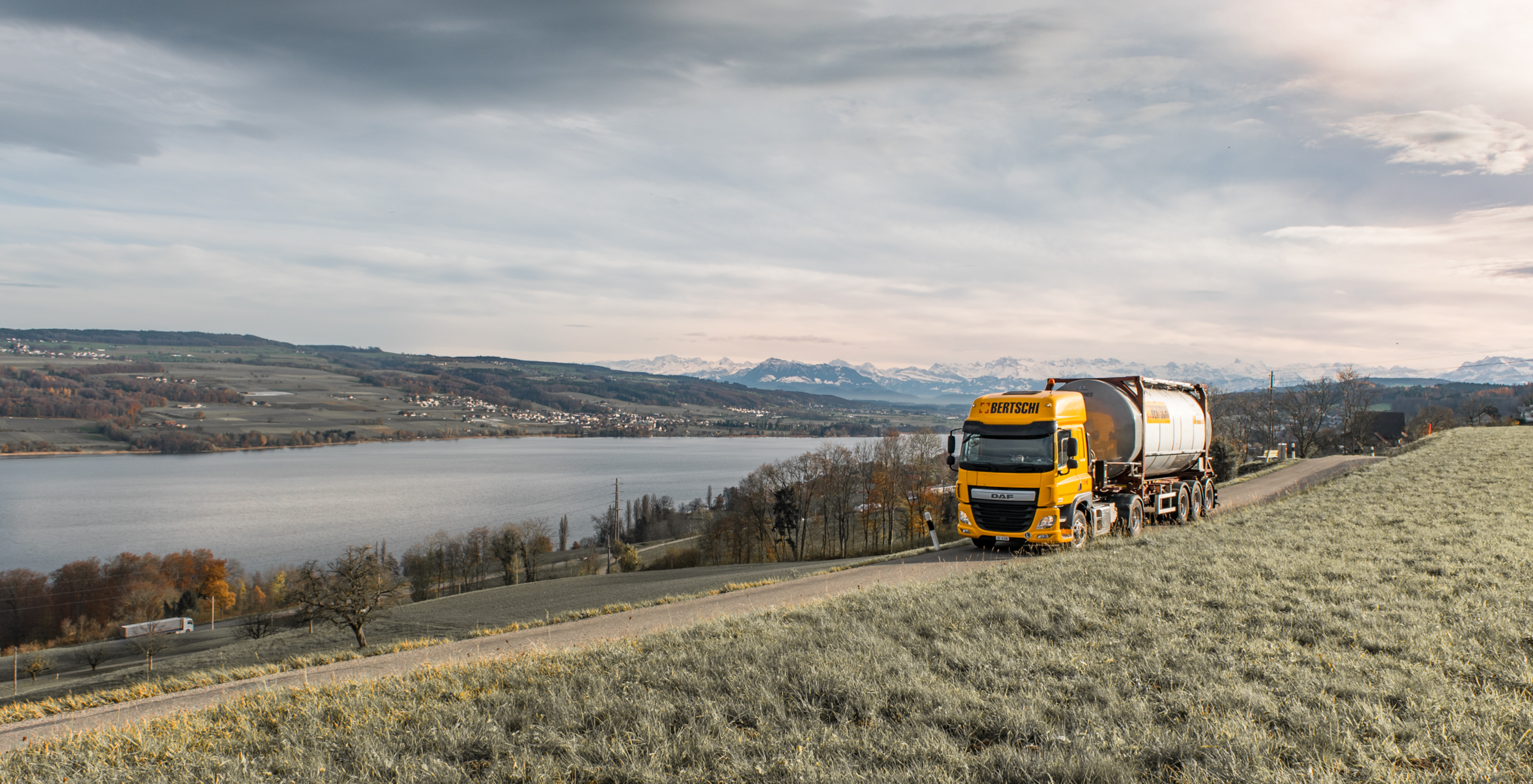 Bertschi truck on the road by the lake