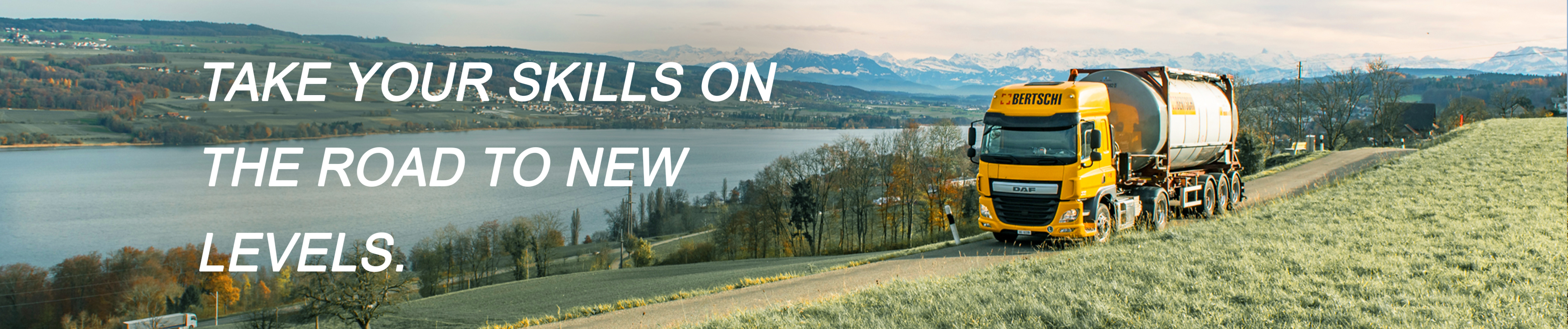 Truck driving by Hallwilersee, with the text "take your skills on the road to new levels"