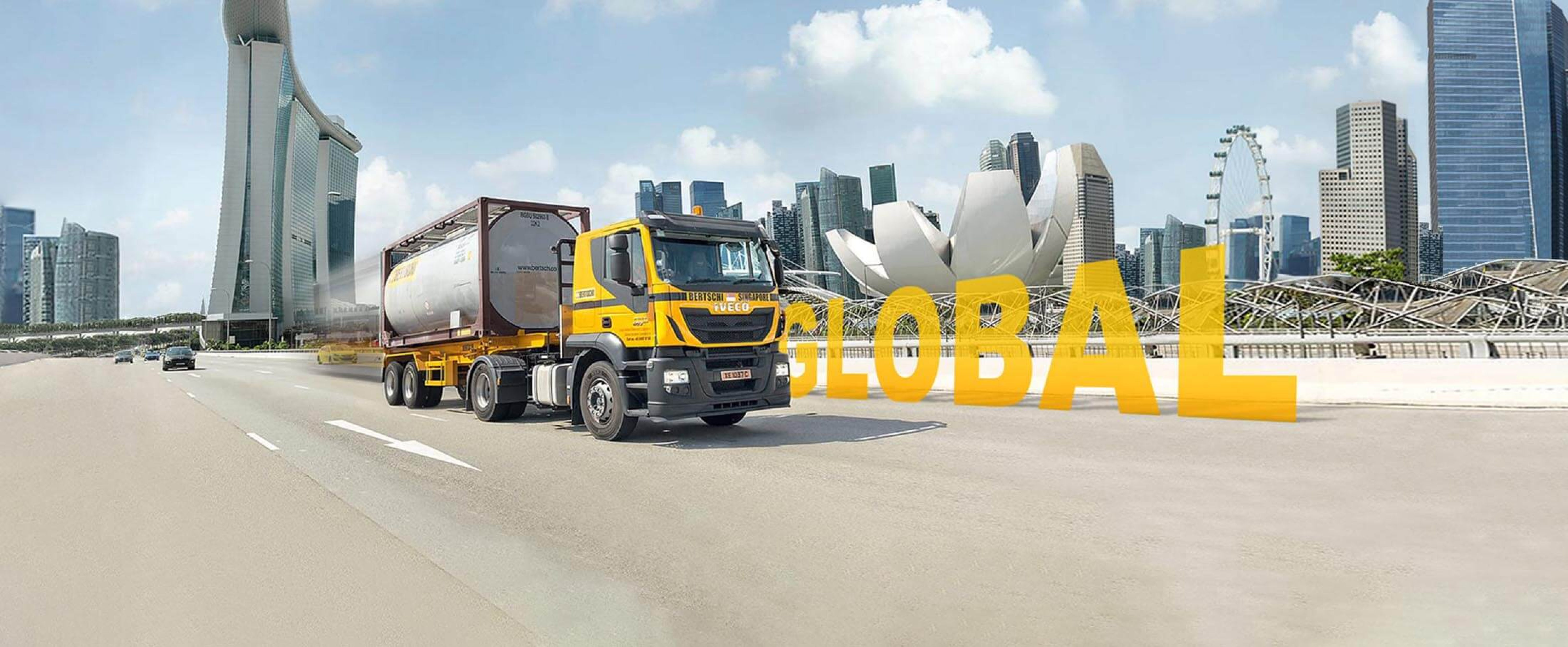 A Bertschi Singapore truck carrying an ISO container in front of Singapore's skyline.