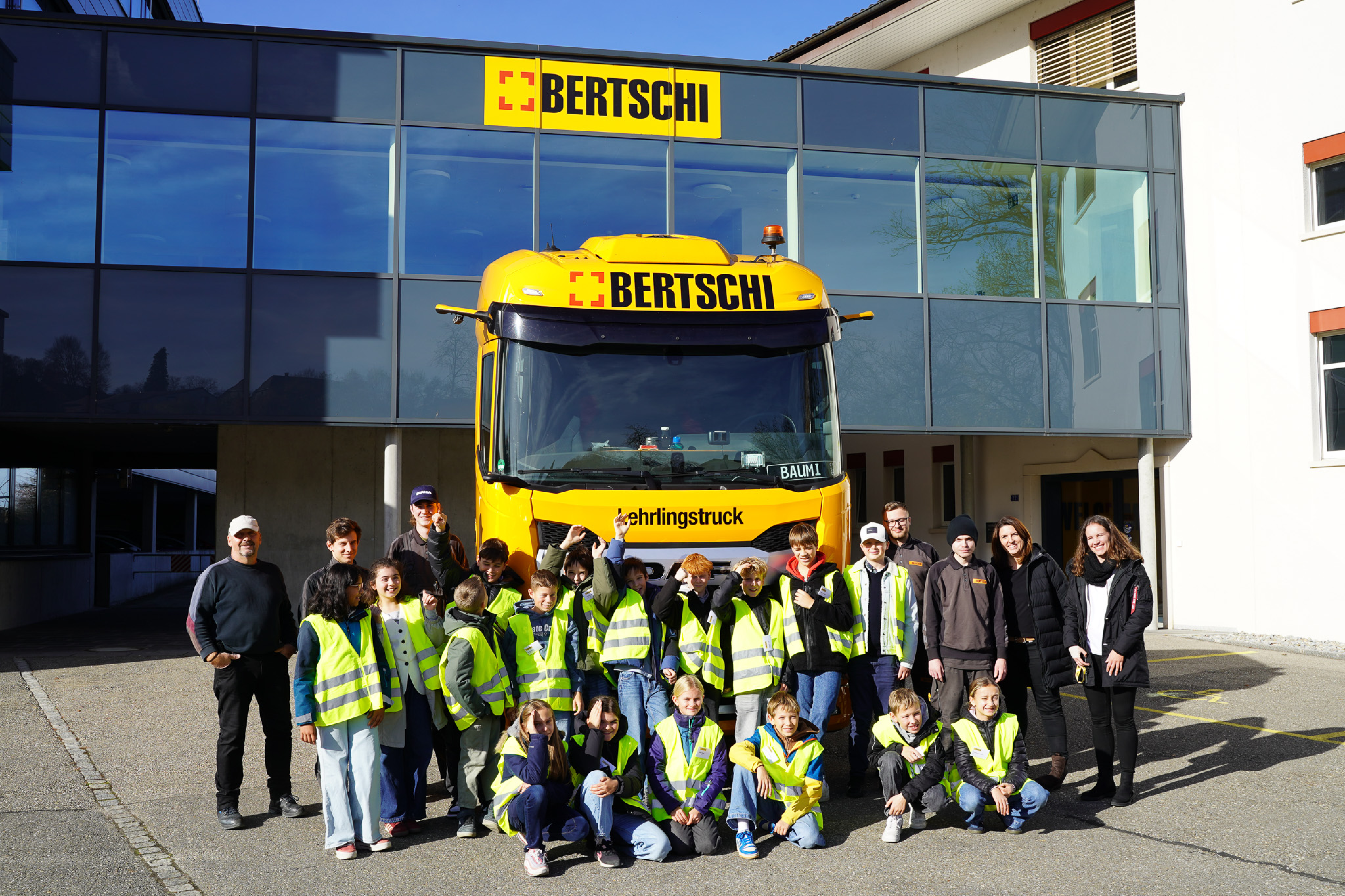 group of kids posing in front of a Bertschi truck