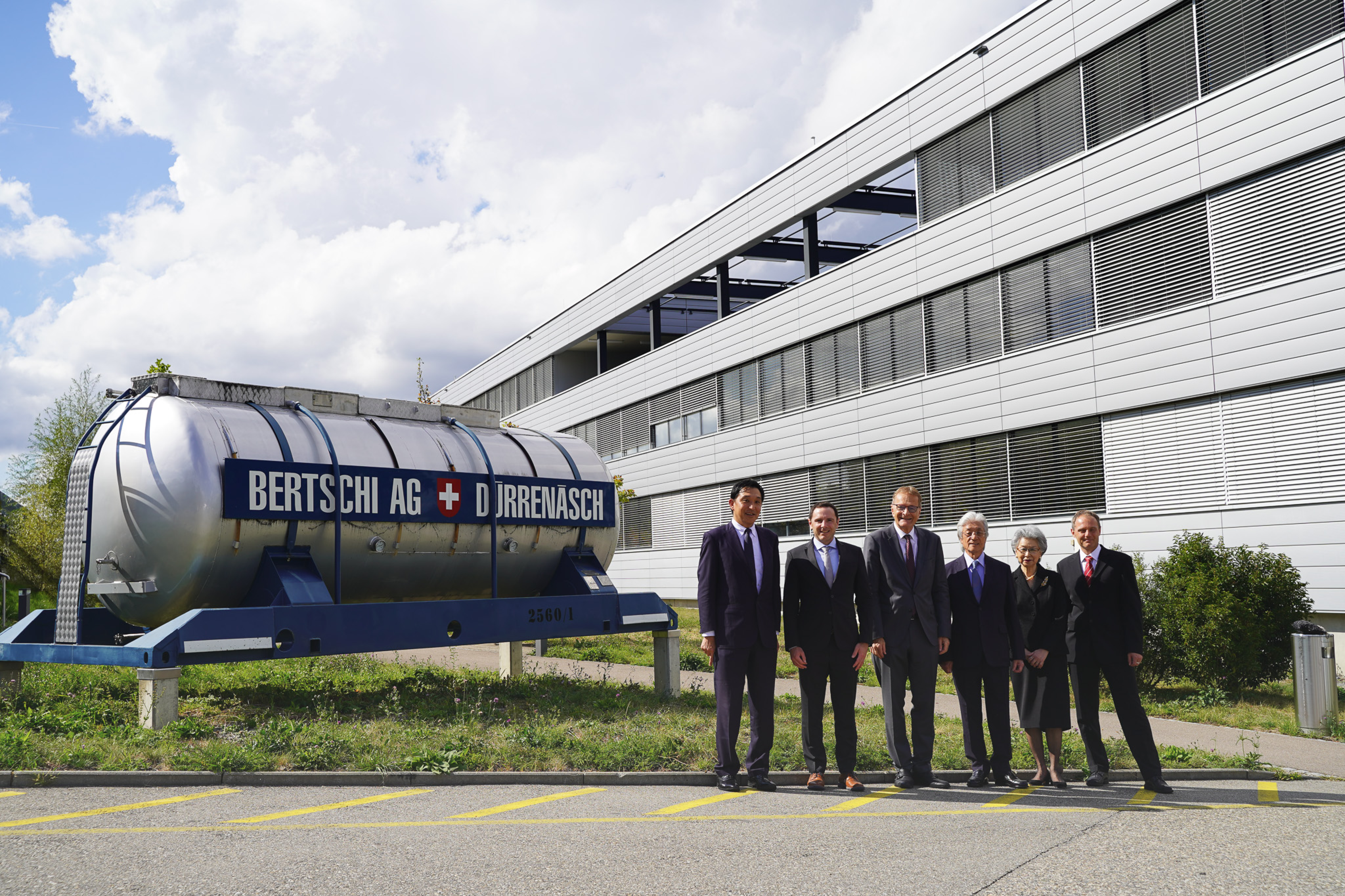 Uyeno Delegation Group Photo standing next to Bertschi Historical Tank Container. From left to right: Yasuki Sato, Jörg Berner, Hans-Jörg Bertschi, Takashi Uyeno, Junko Uyeno, and Markus Berner