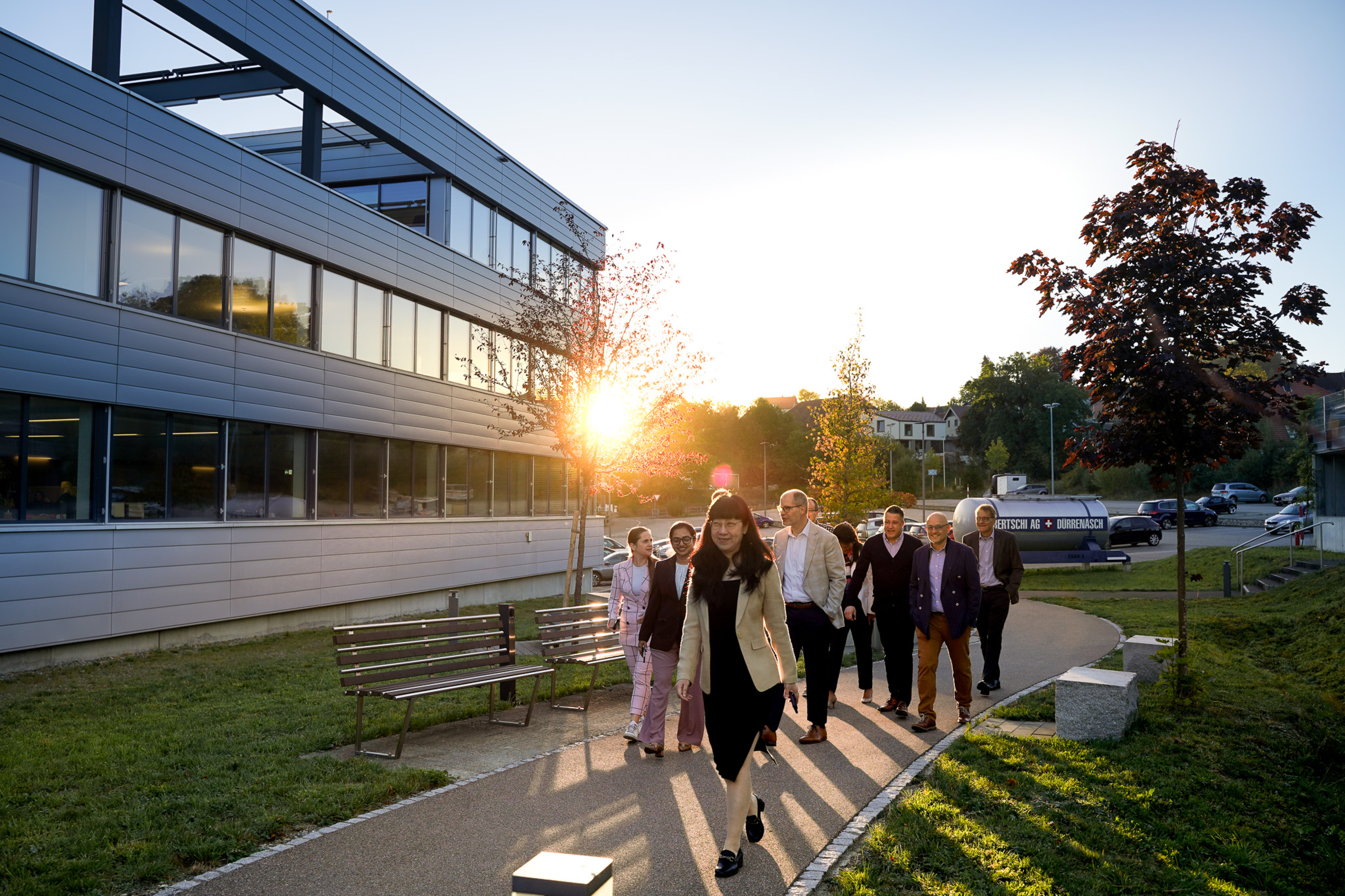 Global GM's walking towards the Bertschi HQ Building with the sunrising behind them