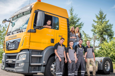 Apprentices posing infront of a Bertchi truck