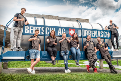 Apprentices posing infront of a Bertchi historic tank container