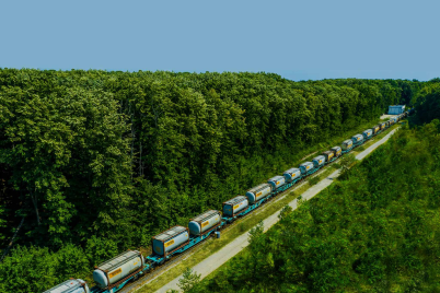 Bertschi tank Containers on a long train between a forest