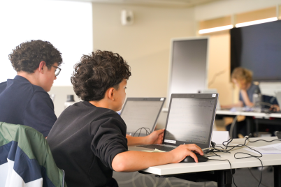 children working on a project on a computer
