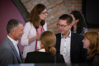 Attendees exchange views during an informal conversation at the petrochemical industry event.