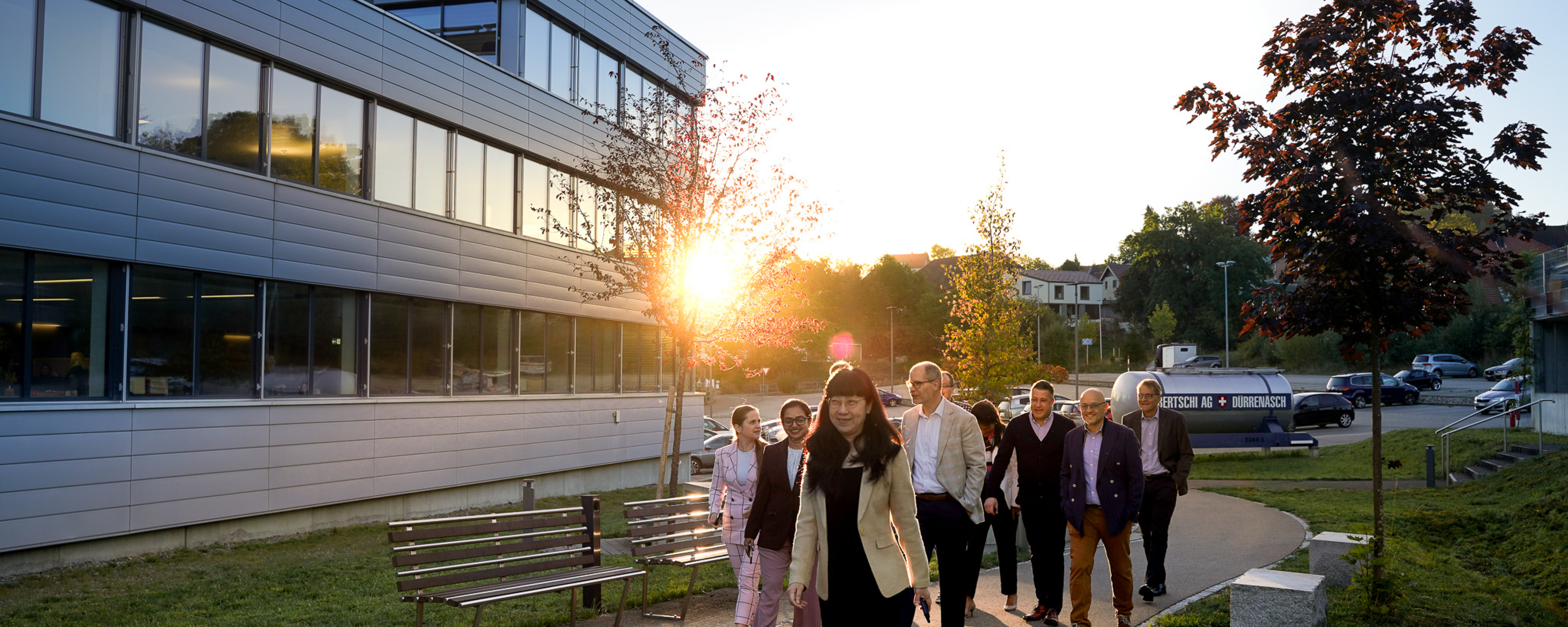 Global GM's walking towards the Bertschi HQ Building with the sunrising behind them